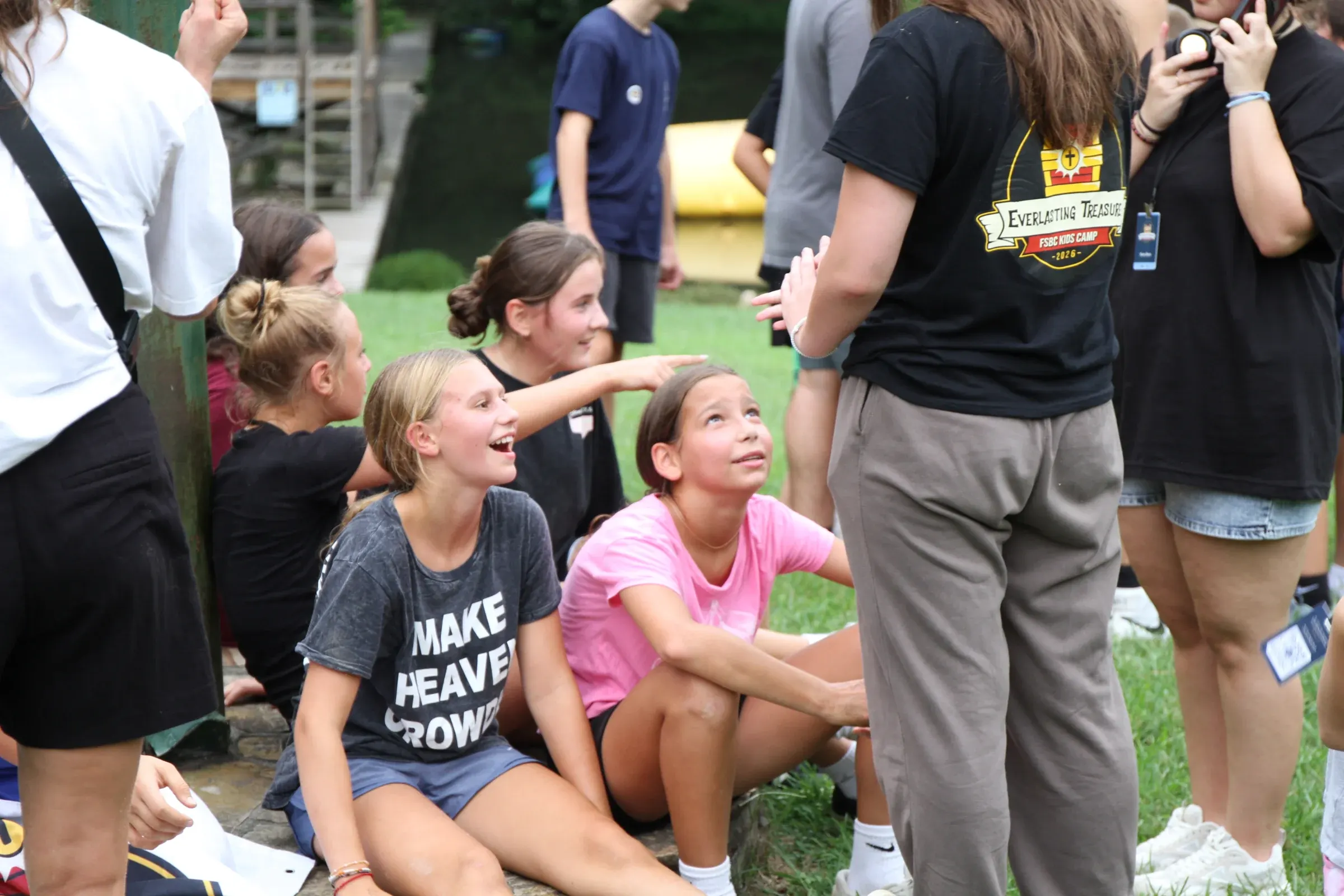 Girls look up laughing as their leader gives the next instruction.